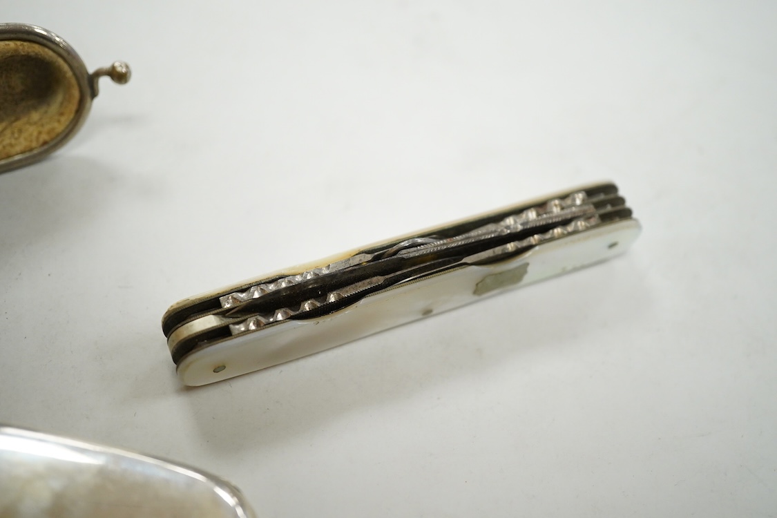 A George V engine turned silver mounted rectangular cigarette box, Birmingham, 1923, 17.7cm, a sterling mounted pepper grinder, four weighted sterling condiments and a small plated tray.